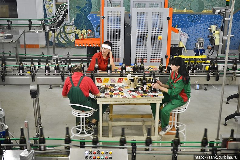 Производство полностью автоматизировано, люди скучают на стульчиках и изредка контролируют готовую продукцию. Абрау-Дюрсо, Россия