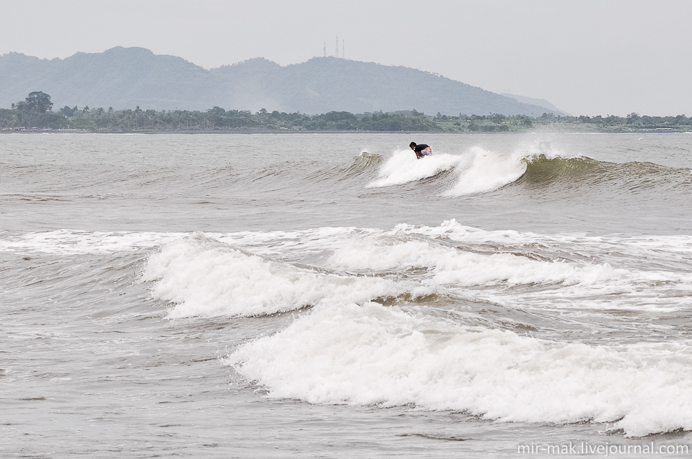 Вдалеке, несколько серферов, неустанно покоряли океанские волны. Бали, Индонезия