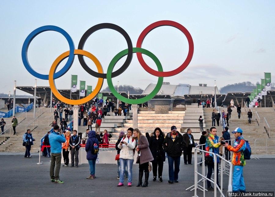 Олимпийские кольца на выходе или входе из парка, а за ними каскадный фонтан. Адлер, Россия