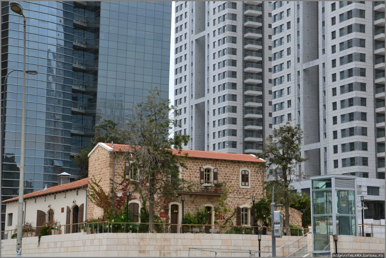 Один из отреставрированных домов немецкого квартала темплеров на фоне новых жилых высоток Тель-Авив, Израиль