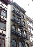 Такие пожарные лестницы на фасадах зданий — обязательный атрибут многоэтажных домов конца 19-го — начала 20-го веков.