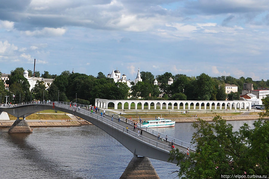 … Две Стороны города соединяют три моста. Один из них – пешеходный, построен на том самом месте, где стоял деревянный Великий мост, на котором новгородцы вели торговлю и сходились «стенка на стенку».

… Вид на мост и Торговую сторону с Софийской звонницы. Сам мост тоже является великолепной точкой для фотосъемок. Великий Новгород, Россия