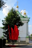 А как празднично на фоне красных флагов смотрится храм Симеона Богоприимца!