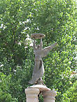 Стела в честь 300-летия Таганрога. В 2009 г. стелу дополнили сверху ангелом-хранителем. Скульптор — Д. Лындин. В народе этот памятник называют баба с люком.