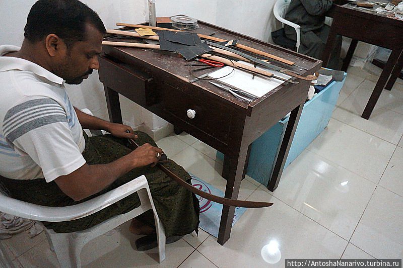 Мужик чистит саблю.