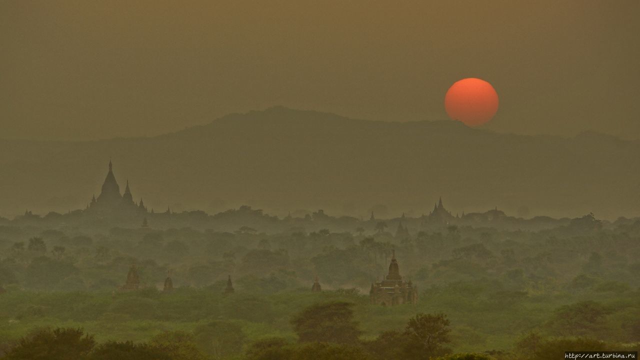 Солнце уходит за горы у реки Иравади. Баган, Мьянма