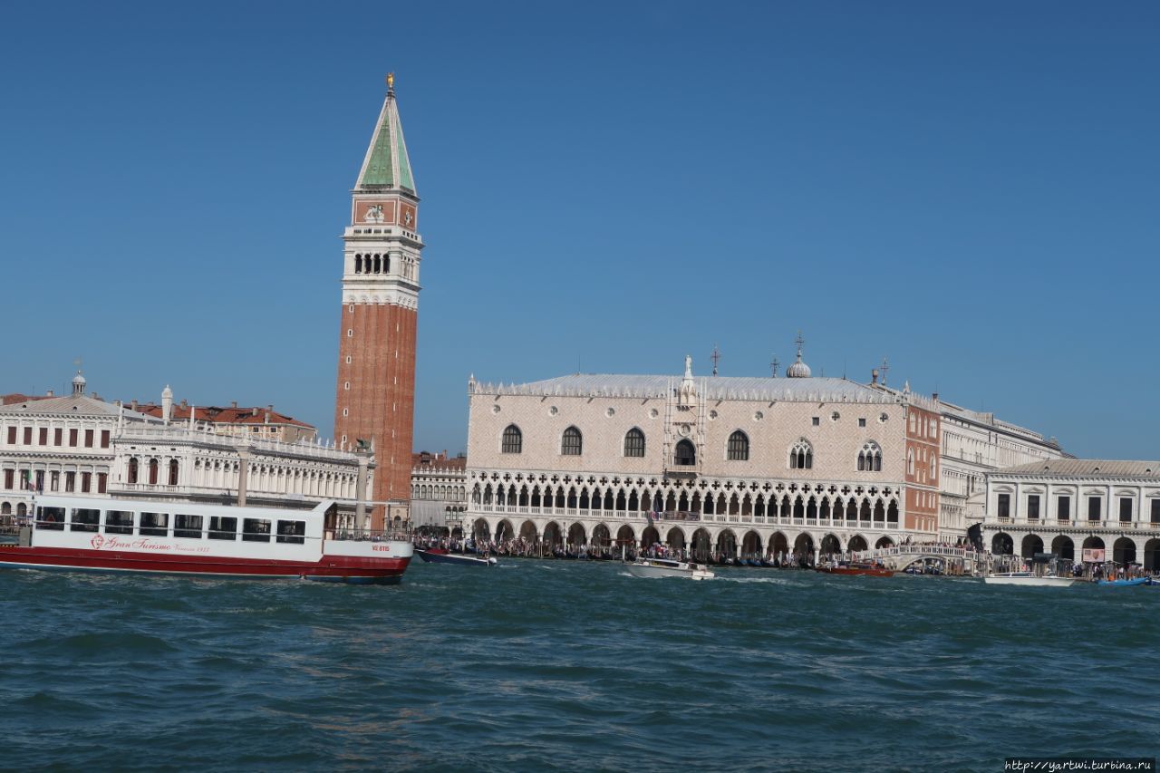 Венеция – один из самых красивых и романтичных городов мира. Сюда стремятся приехать туристы из разных уголков планеты, чтобы полюбоваться здешним колоритом и пройтись по прекрасным улицам, которые пролегают ниже уровня моря. Такую фотографию площади Святого Марка можно сделать при переезде с материковой части. Венеция, Италия