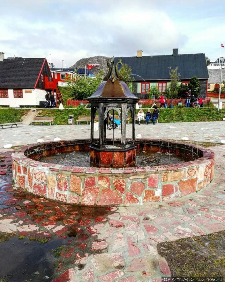 Фонтан с китами на площади. Некогда Какорток был единственным городом с фонтаном на острове Какорток, Гренландия